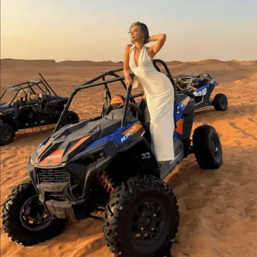 2-Seater Polaris Dune Buggy 1 Hour – Dubai Desert Ride Two riders in a 2-seater Polaris RZR dune buggy, one-hour desert ride Dubai