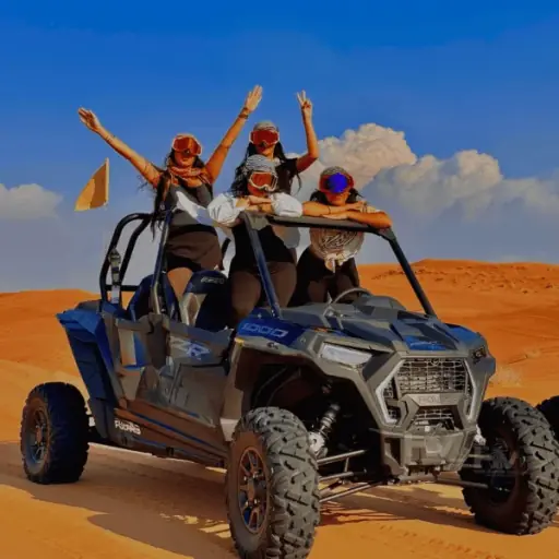Family of 4 in a Polaris RZR 4-seater dune buggy on Dubai desert dunes
