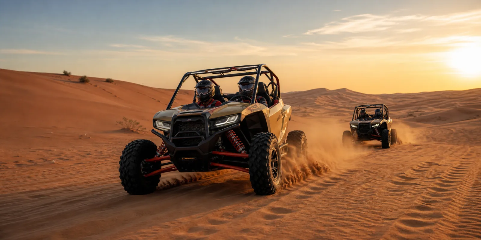 Guided dune buggy convoy crossing Lahbab Desert red dunes at golden hour