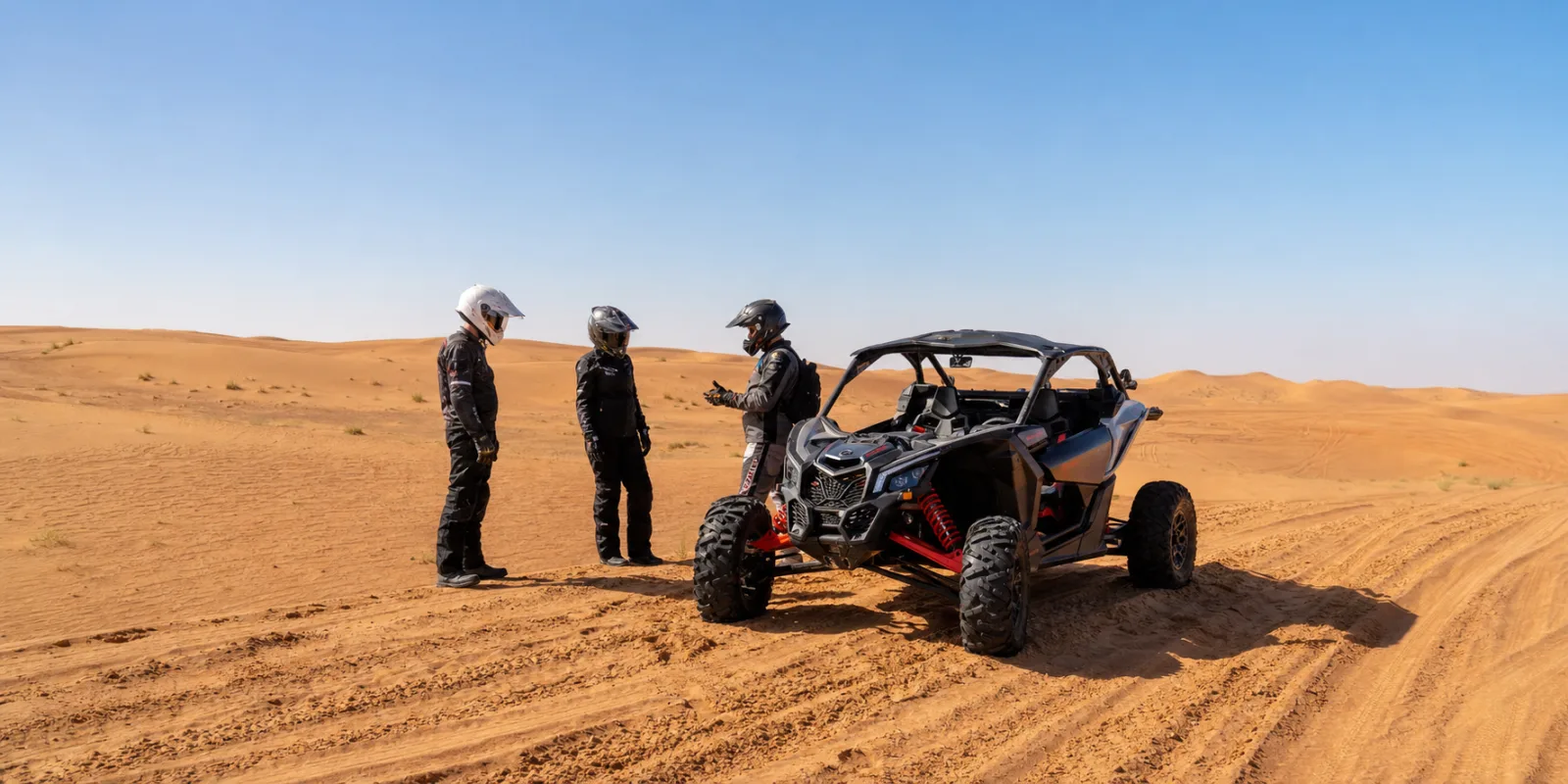 Midday dune buggy Dubai rest stop on Lahbab Desert dunes with guide and safety gear