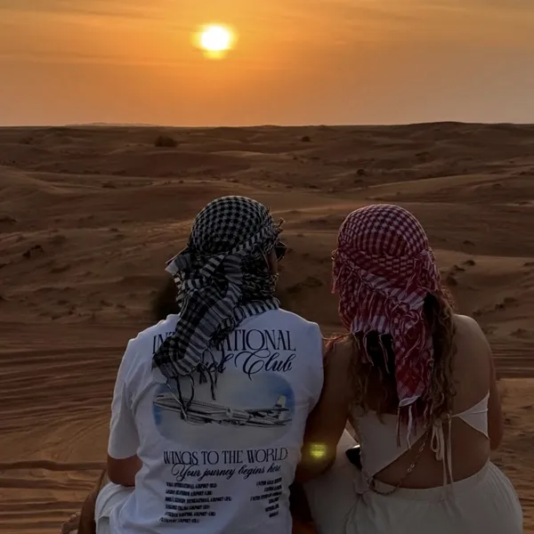 Guests watching the sunset before a premium live cooking desert safari camp dinner