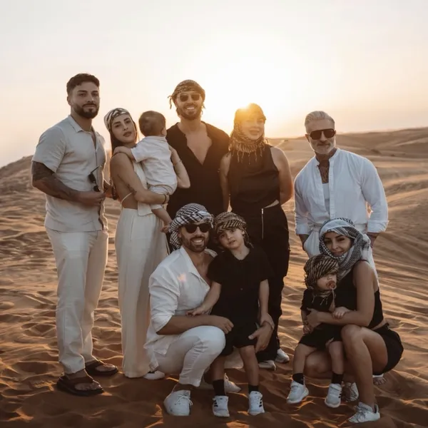PRIVATE CAR SAFARI Private group posing on Lahbab red dunes during a Dubai private car desert safari